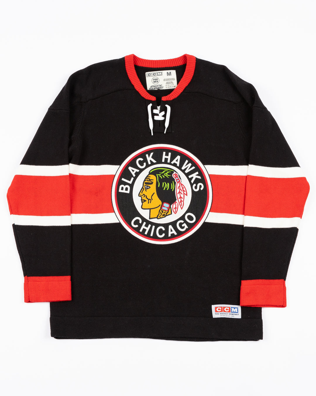 black CCM heritage sweater with vintage Chicago Blackhawks logo across front and lace detail on neck - front lay flat