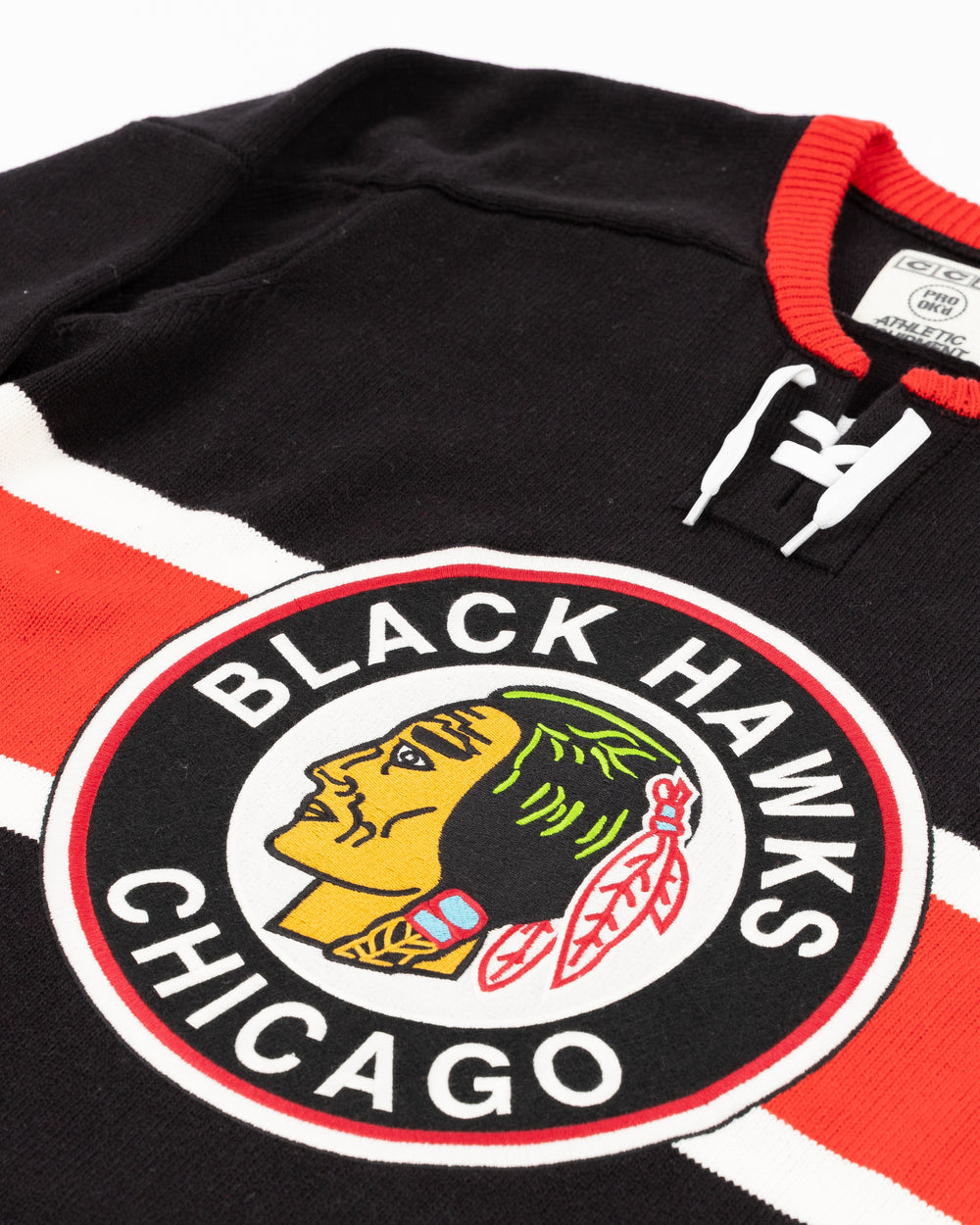 black CCM heritage sweater with vintage Chicago Blackhawks logo across front and lace detail on neck - front detail lay flat