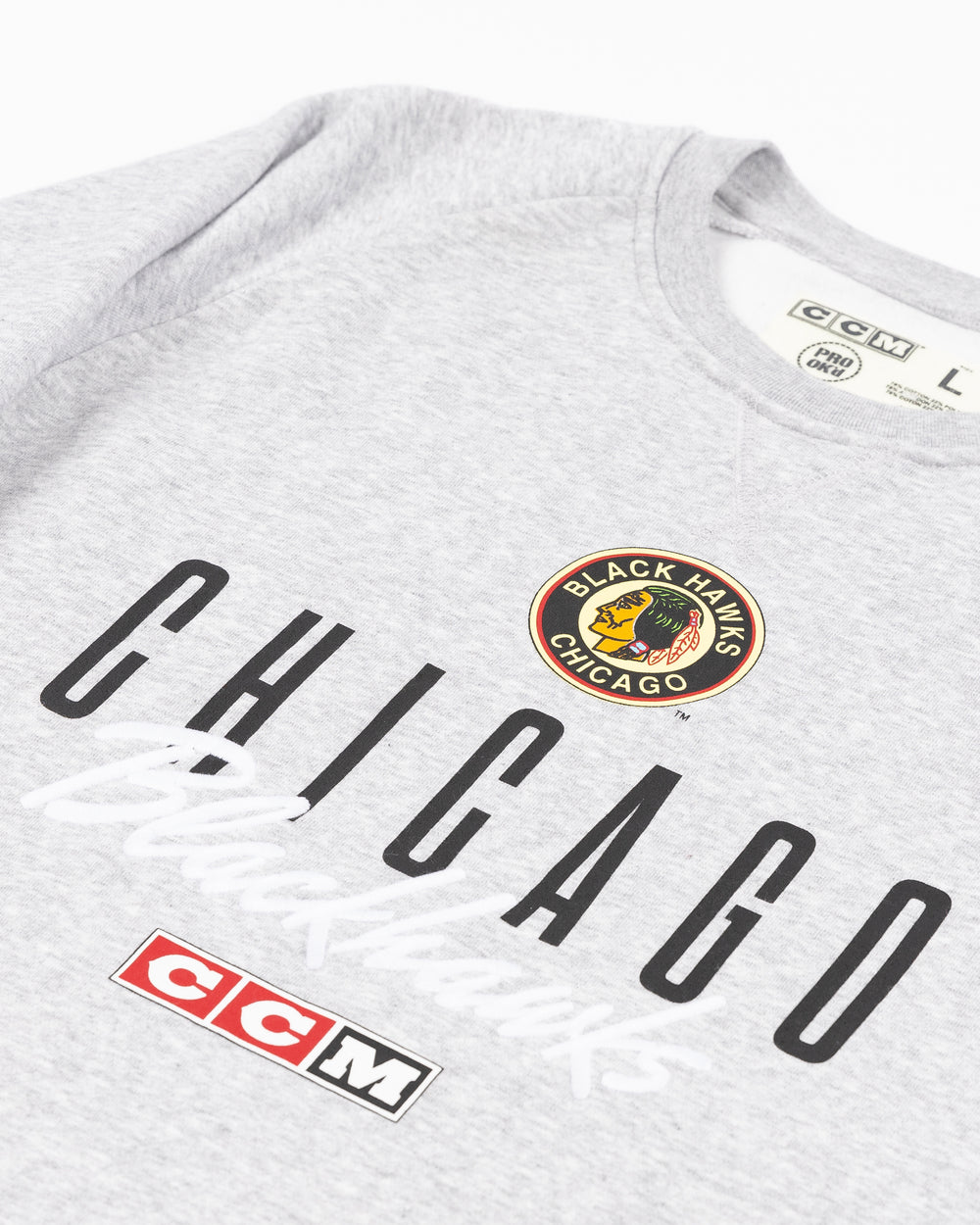 grey CCM crewneck with vintage Chicago Blackhawks logo and wordmark across the front - front detail lay flat