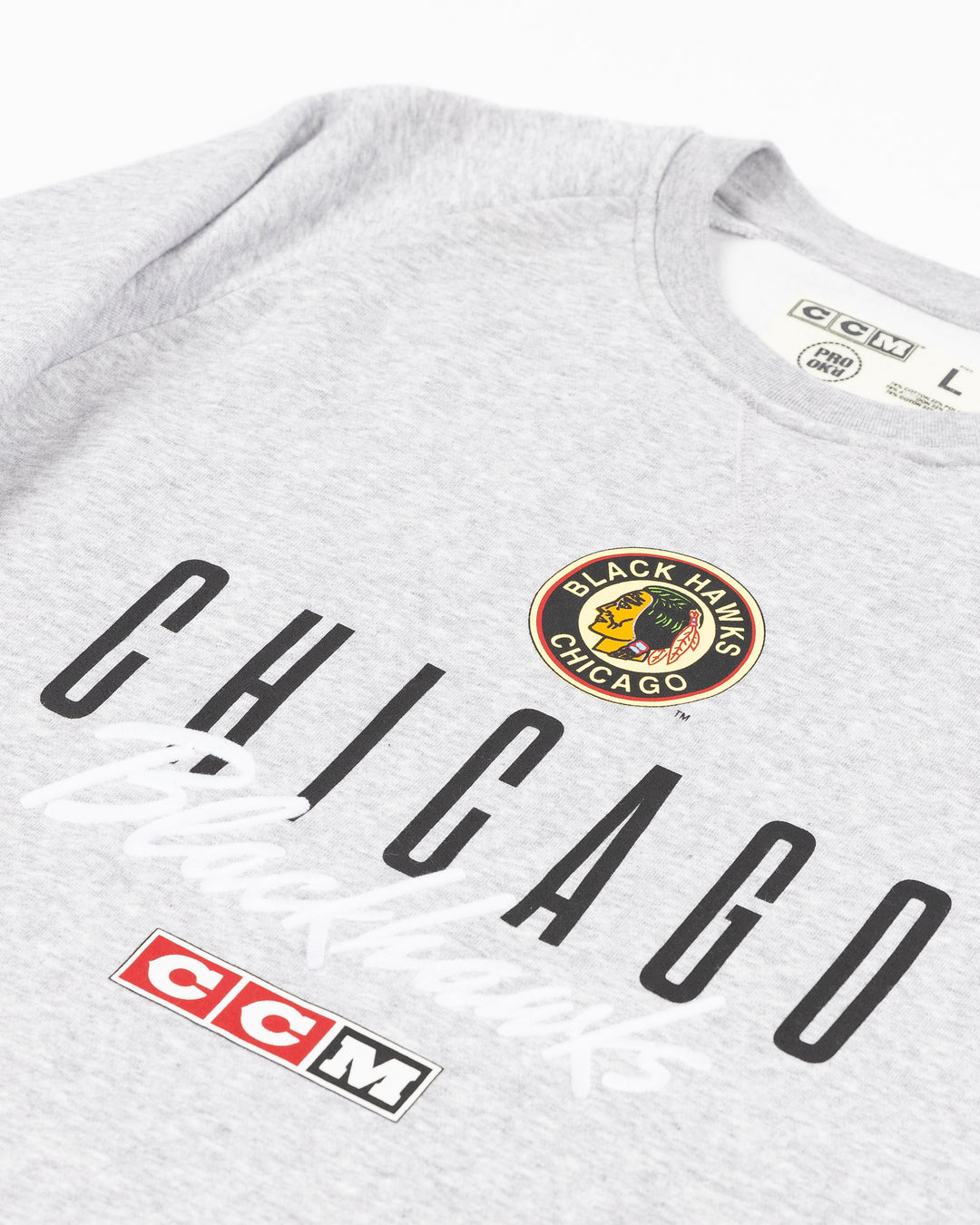 grey CCM crewneck with vintage Chicago Blackhawks logo and wordmark across the front - front detail lay flat