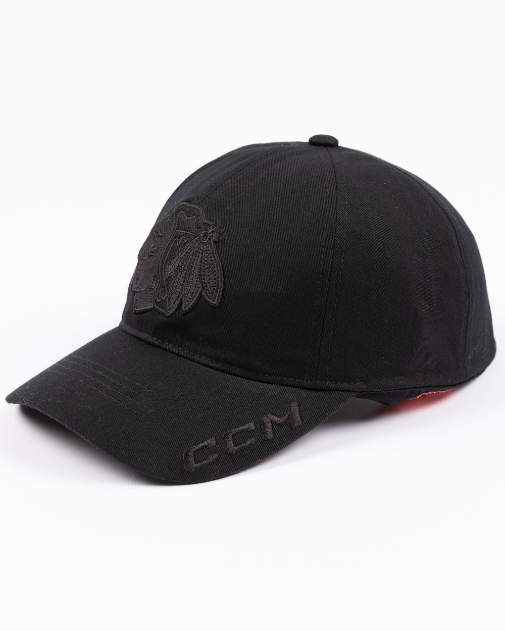 black CCM adjustable hat with tonal Chicago Blackhawks primary logo on front and tonal CCM logo on brim - left angle lay flat