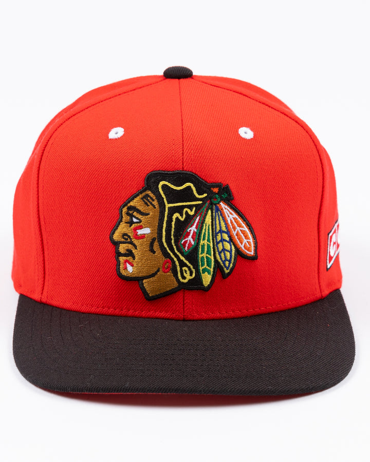 two tone red and black CCM flat brim hat with Chicago Blackhawks primary logo embroidered on front and CCM logo on left side - front lay flat