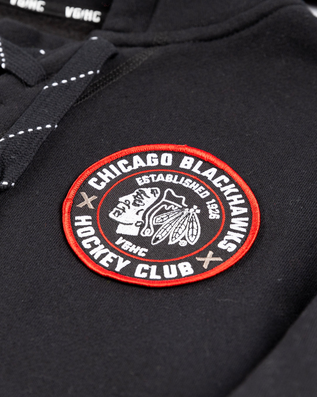 black VGHC lacer hoodie with Chicago Blackhawks branding on chest, left sleeve and back - front detail lay flat