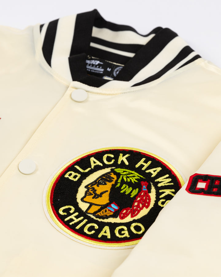 cream satin Pro Standard varsity jacket with vintage Chicago Blackhawks patches on shoulders, chest and back - front detail and collar lay flat