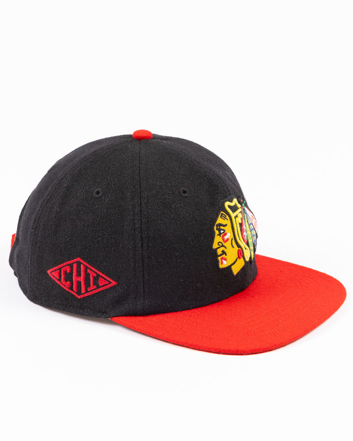 two tone black and red adjustable '47 brand hat with Chicago Blackhawks primary logo on front and CHI logo on right side - right angle lay flat