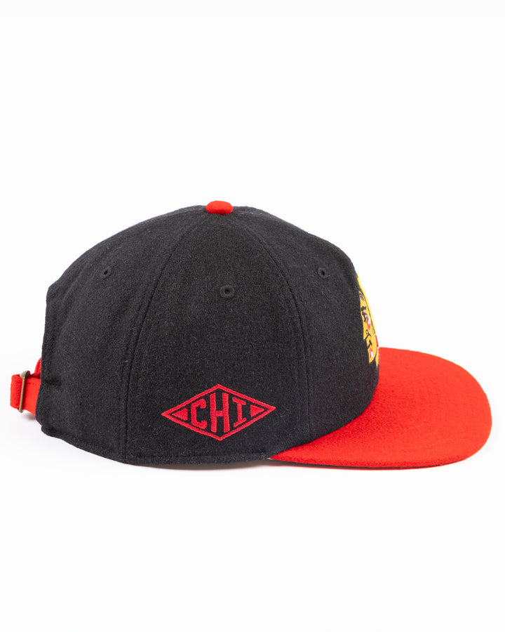 two tone black and red adjustable '47 brand hat with Chicago Blackhawks primary logo on front and CHI logo on right side - right side lay flat