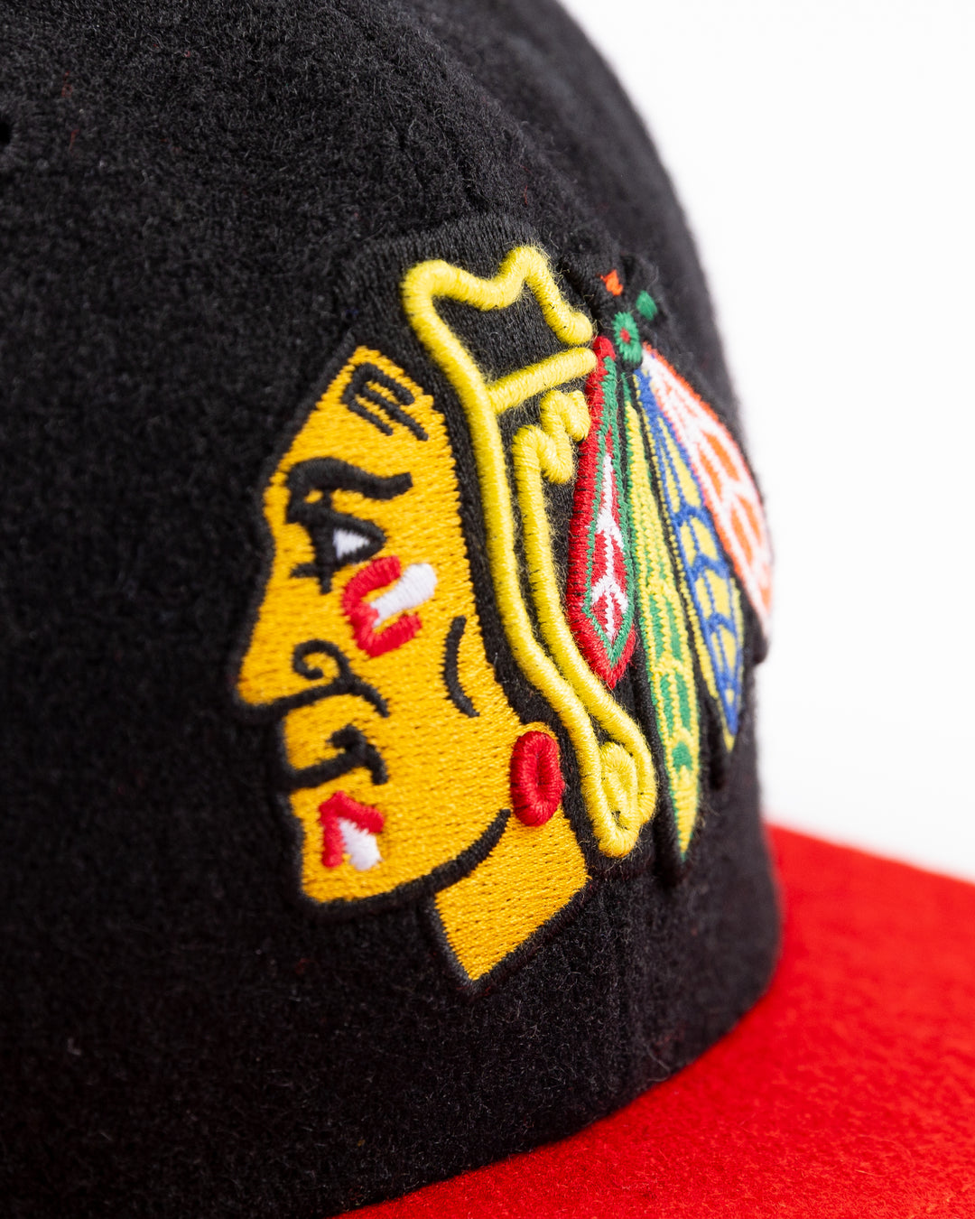 two tone black and red adjustable '47 brand hat with Chicago Blackhawks primary logo on front and CHI logo on right side - front detail lay flat