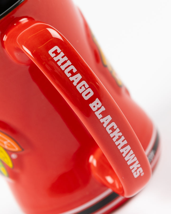 red ceramic mug inspired by Chicago Blackhawks hockey jersey with primary logo on front - handle detail lay flat