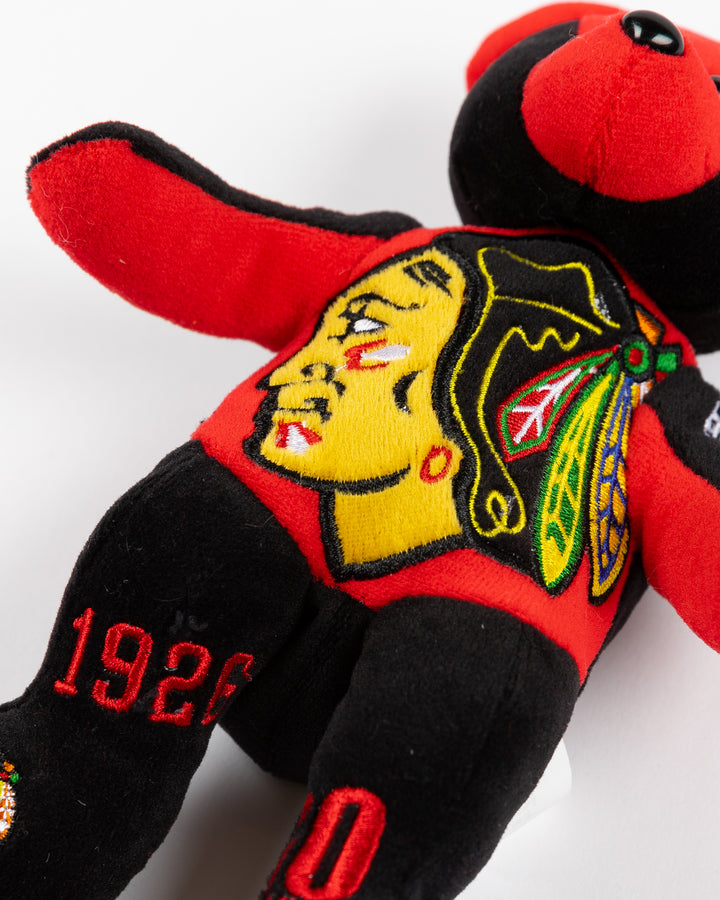 red and black plush bear with Chicago Blackhawks branding embroidered throughout - front detail lay flat