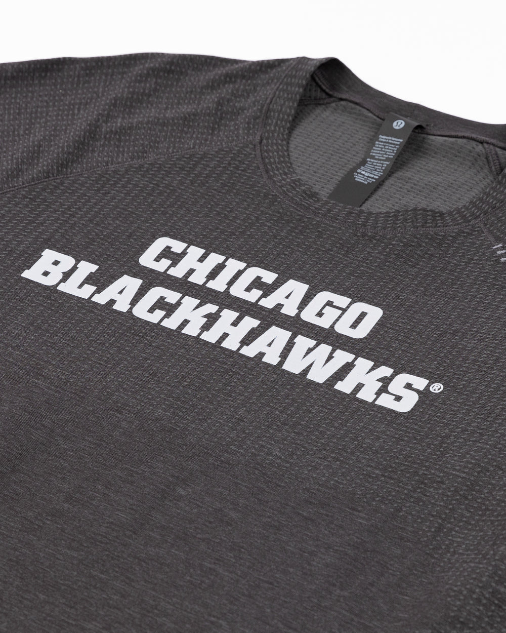 black lululemon short sleeve tee with Chicago Blackhawks wordmark across front - front detail lay flat