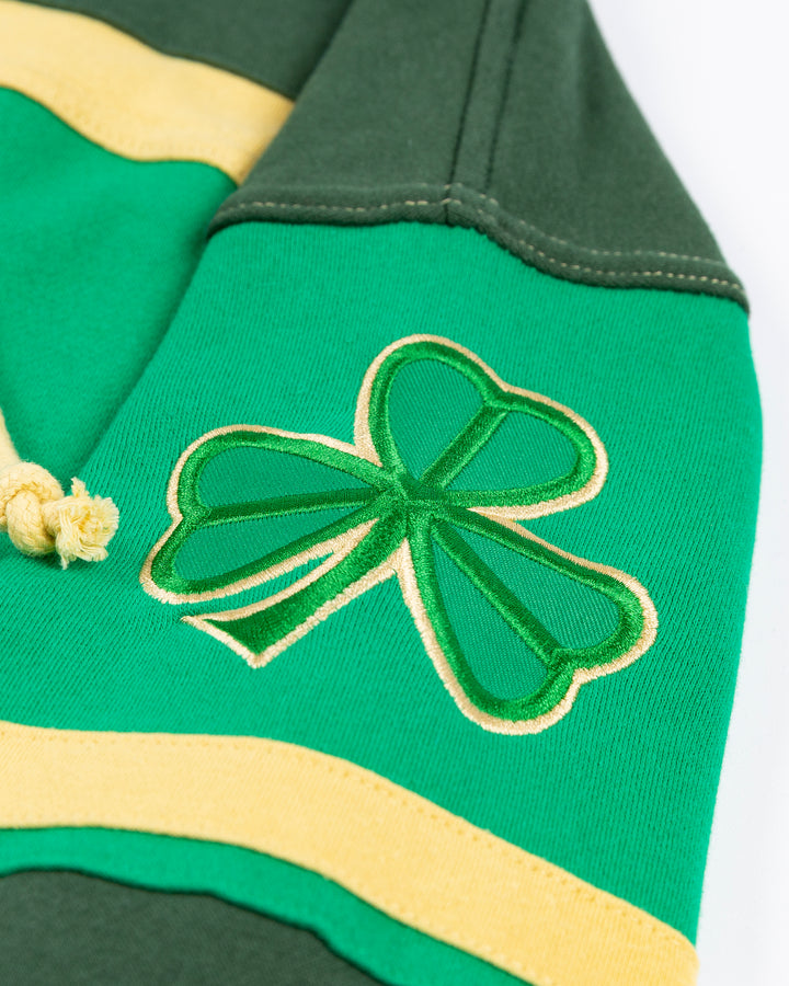 green and gold '47 brand hockey jersey inspired lacer hoodie with Irish inspired Blackhawks design on front and shamrocks on sleeves - shamrock detail lay flat