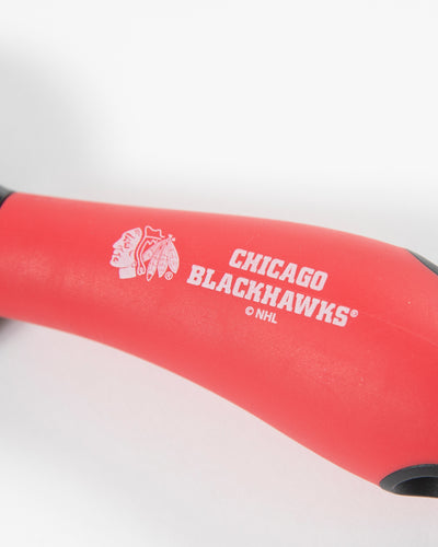 Metal pizza cutter with Chicago Blackhawks branding on blade and handle - detail handle lay flat