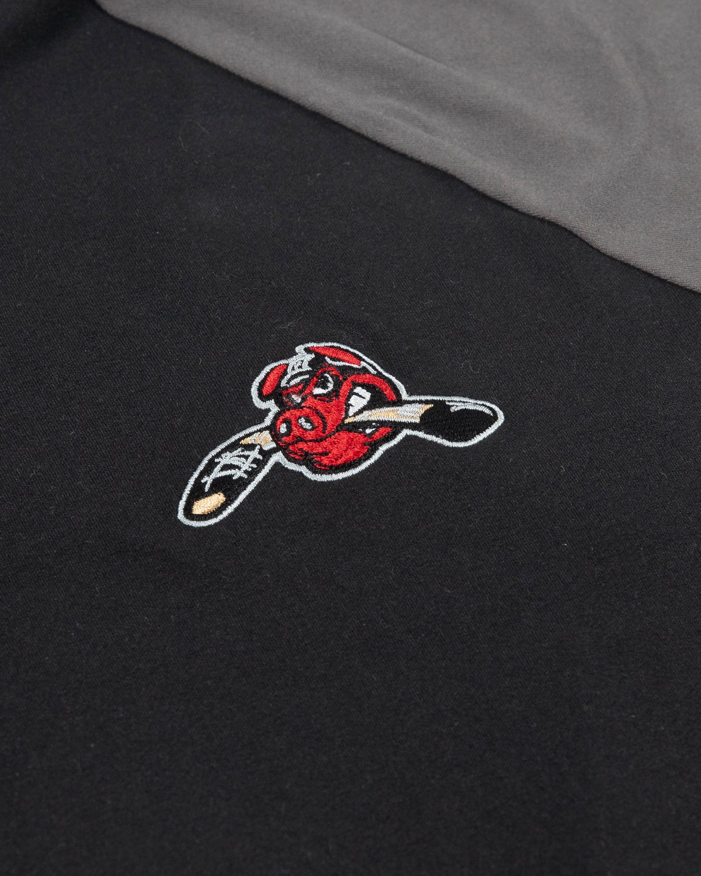 Black and grey two tone Rockford IceHogs Colosseum quarter zip with Hammy embroidered on left chest - detail lay flat
