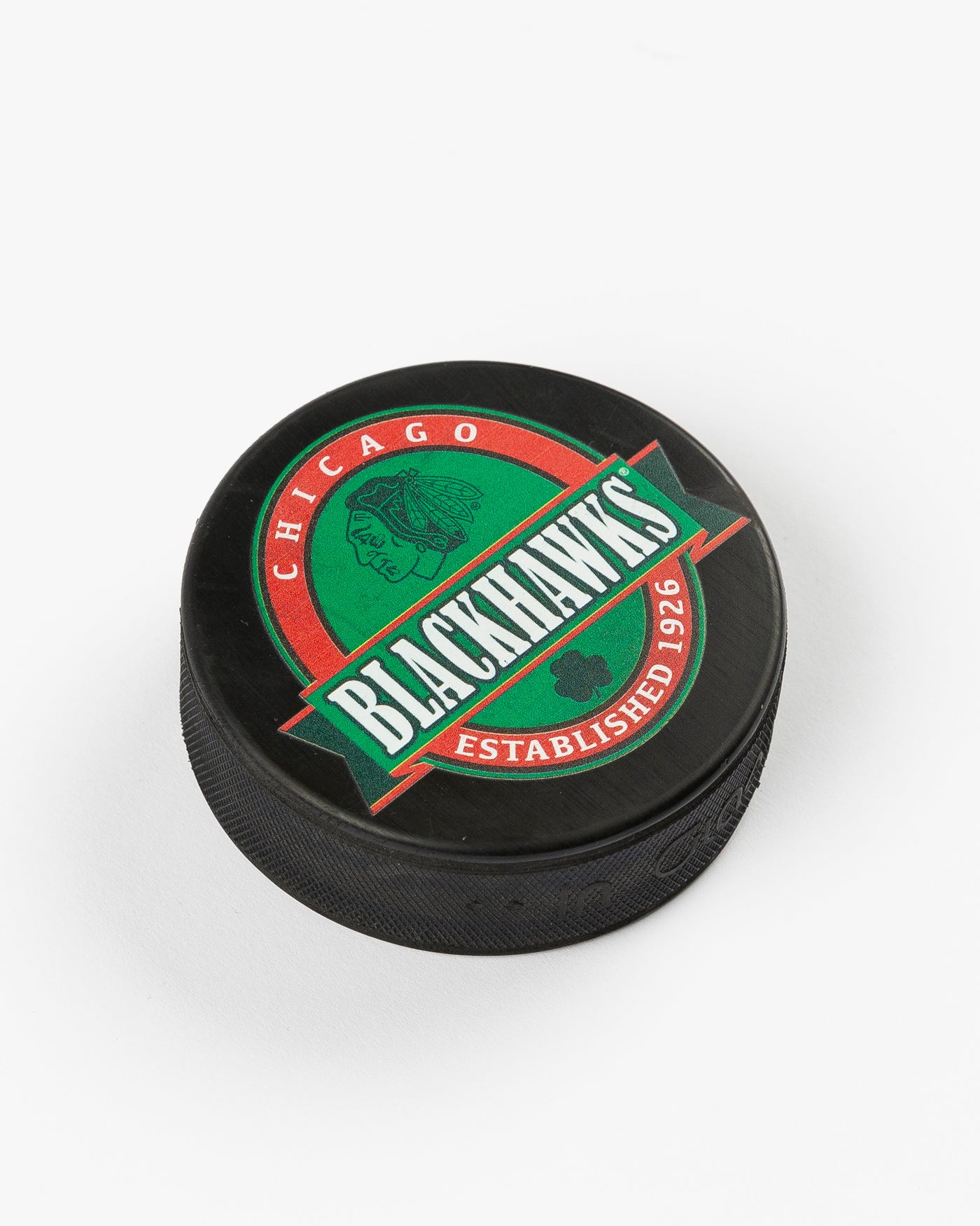 black green and red Chicago Blackhawks St. Patrick's Day puck - angled lay flat