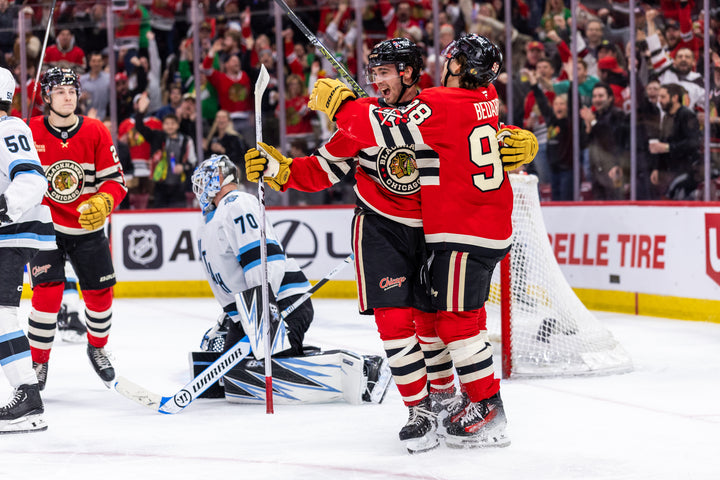 Chicago Blackhawks players Wyatt Kaiser and Connor Bedard celebrating Kaiser goal against Utah
