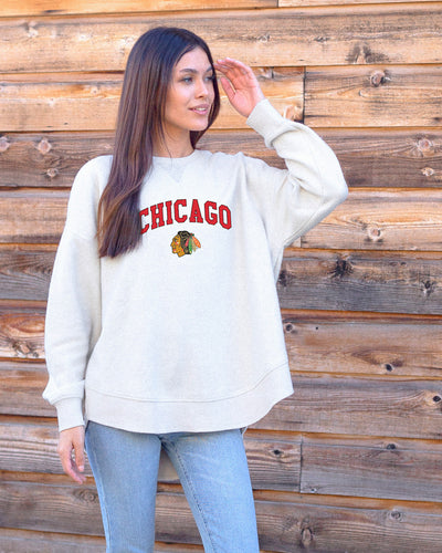 white chicka-d ladies crewneck with Chicago wordmark and Chicago Blackhawks primary logo - on model 