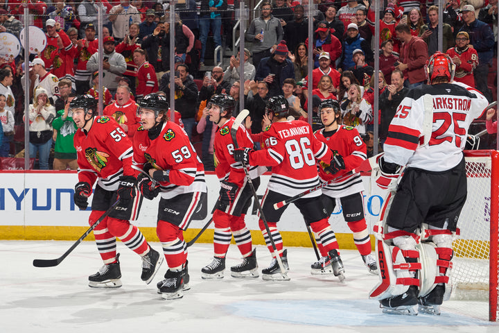 Chicago Blackhawks players celebrating score by Tyler Bertuzzi against the New Jersey Devils