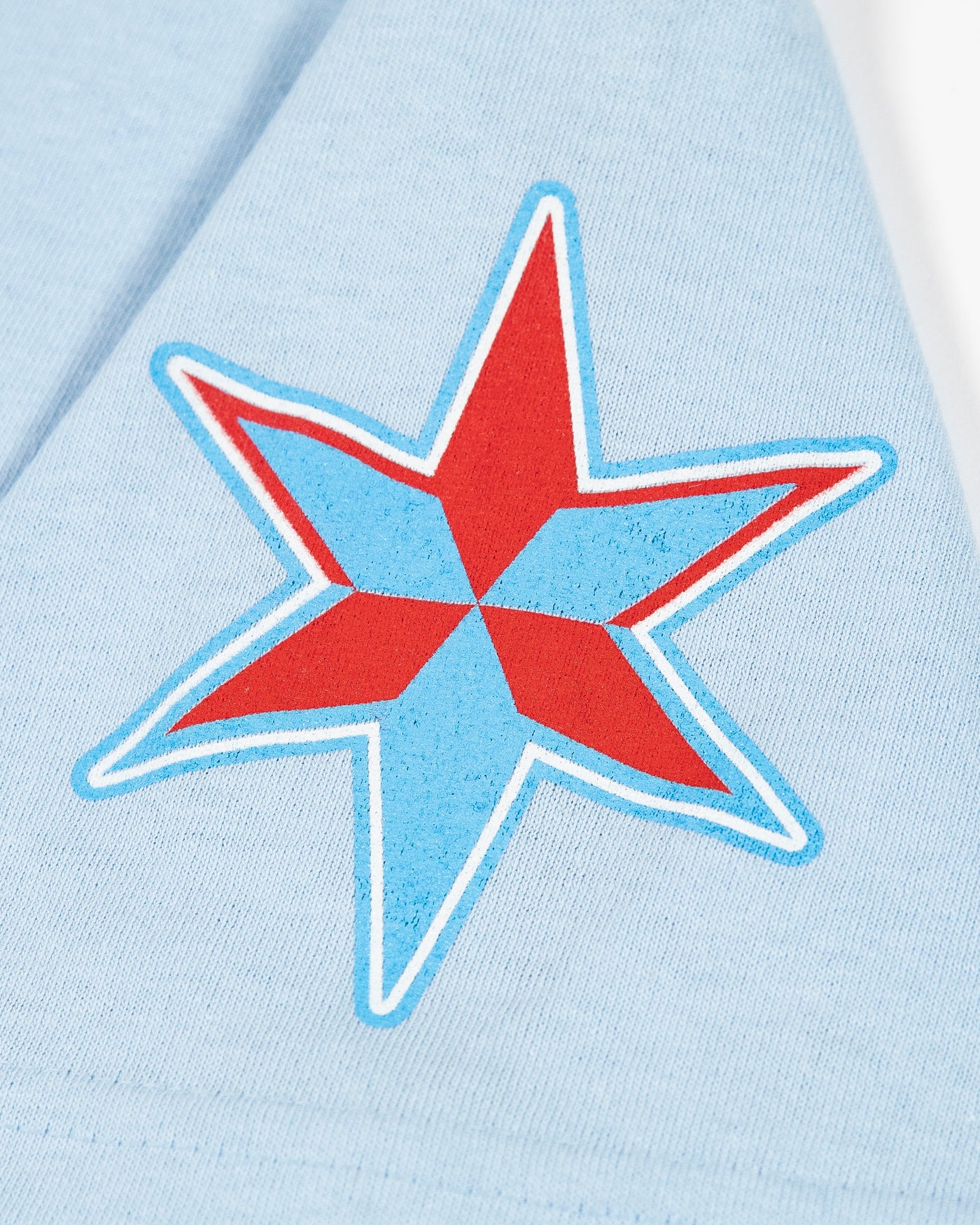 light blue tee with tonal Chicago Blackhawks primary logo across chest, tonal secondary logo on right shoulder and star graphic on left shoulder - star graphic detail image