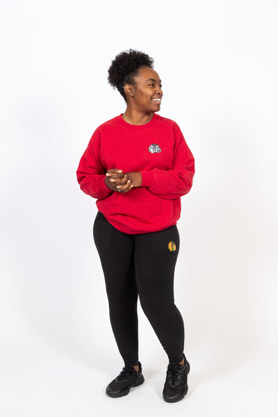 black lululemon women's jogger with full color Chicago Blackhawks primary logo on left leg - on model