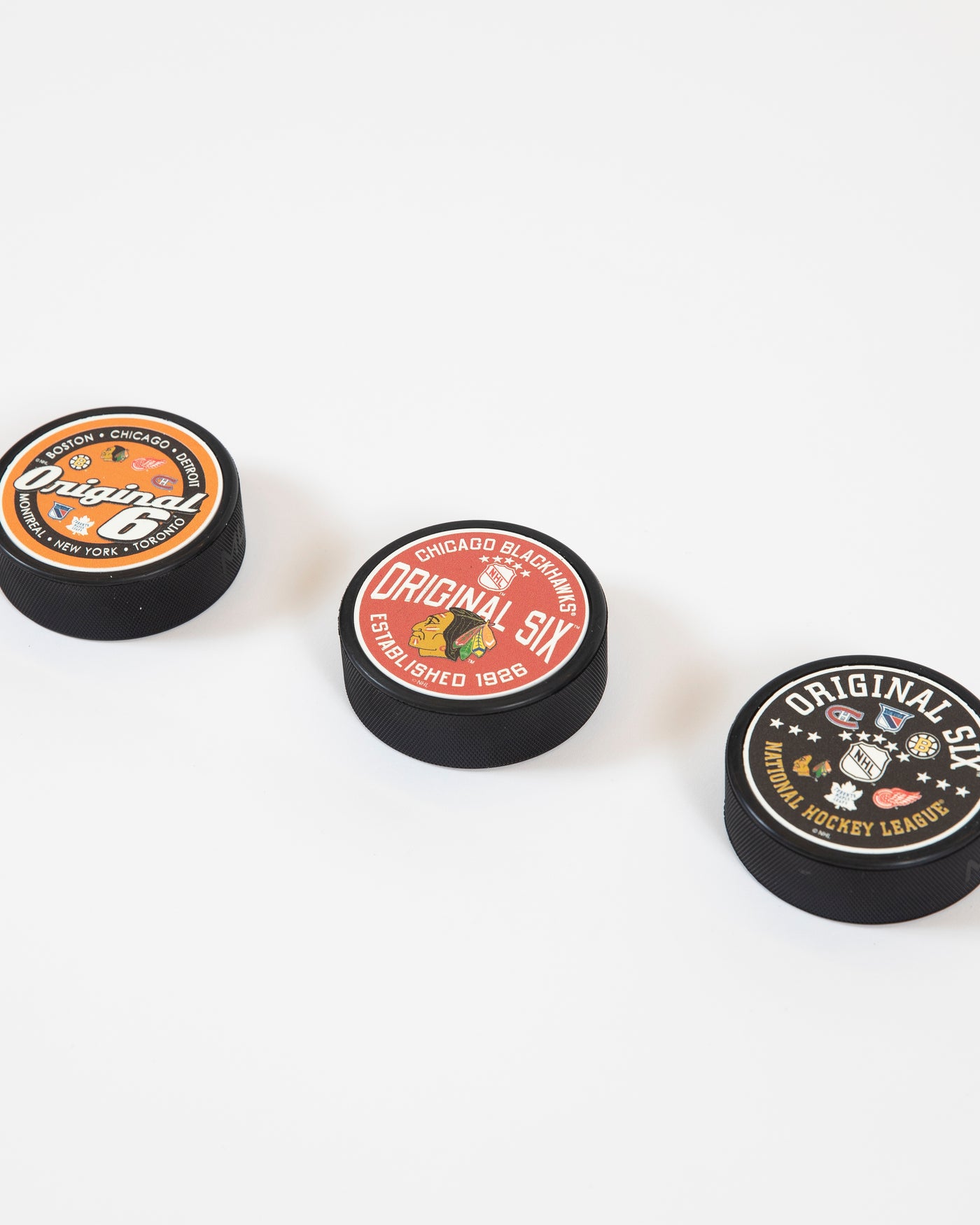 Mustang black puck with Original Six and NHL wordmark with all six team logos - collection shot