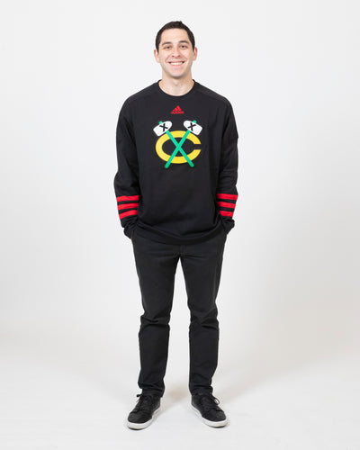 adidas black Chicago Blackhawks secondary logo sweater with three red stripes along wrist - front view