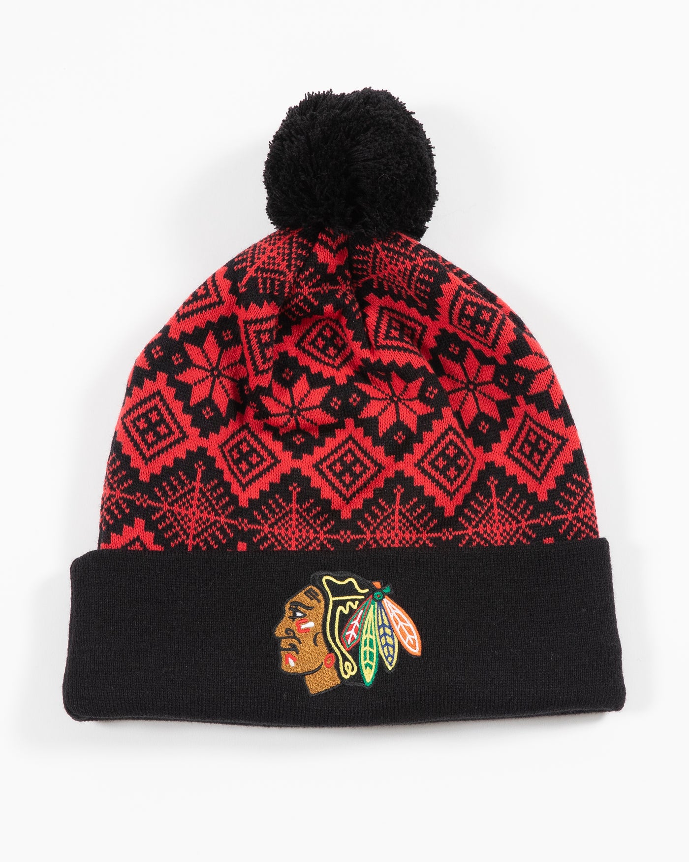 CCM Chicago Blackhawks knit hat with holiday pattern in red and black with black pom and primary logo embroidered on the front black cuff - front view