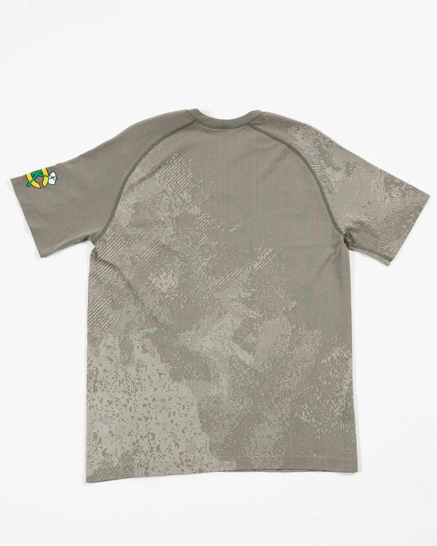 green patterned lululemon technical tee with secondary logo on left shoulder - back lay flat