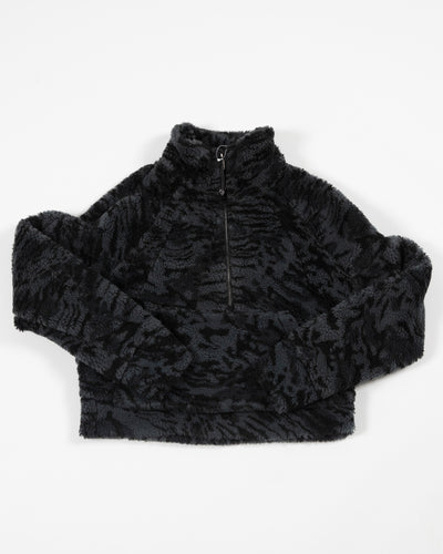 black camo fuzzy lululemon half zip jacket with black tonal Chicago Blackhawks primary logo on left shoulder - front lay flat 