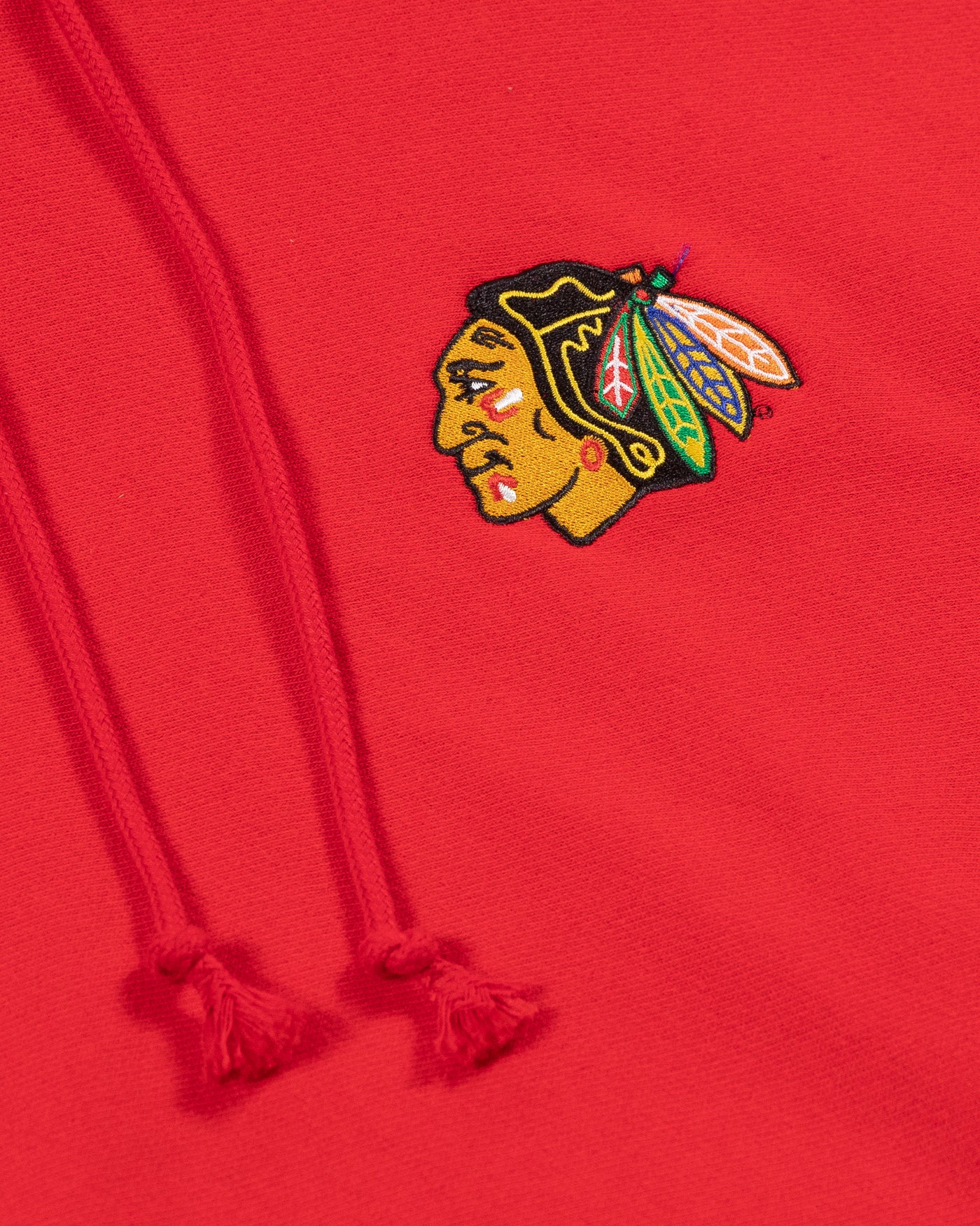 red Champion hoodie with Chicago Blackhawks primary logo embroidered on left chest - detail lay flat