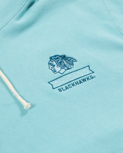 Champion Chicago Blackhawks light blue tonal hoodie with embroidered primary logo and Chicago Blackhawks wordmark on left chest - detail view 