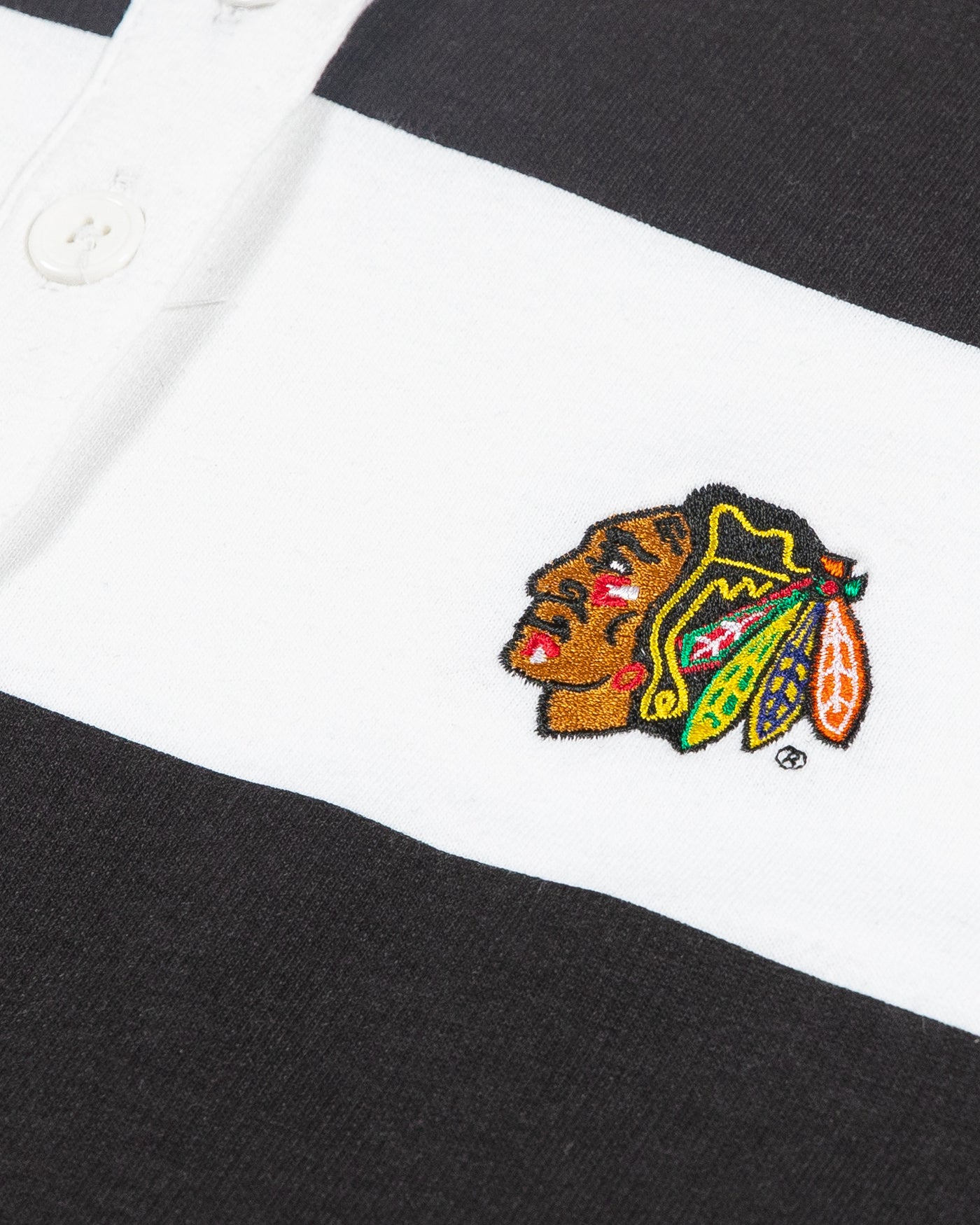 black and white striped rugby shirt with embroidered Chicago Blackhawks primary logo on left chest - detail lay flat