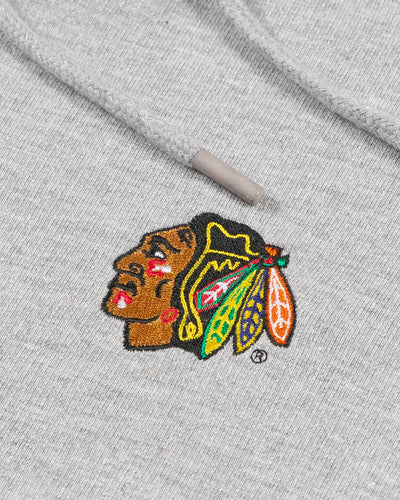 grey and white striped Antigua sweatshirt with embroidered Chicago Blackhawks primary logo on left chest - detail lay flat
