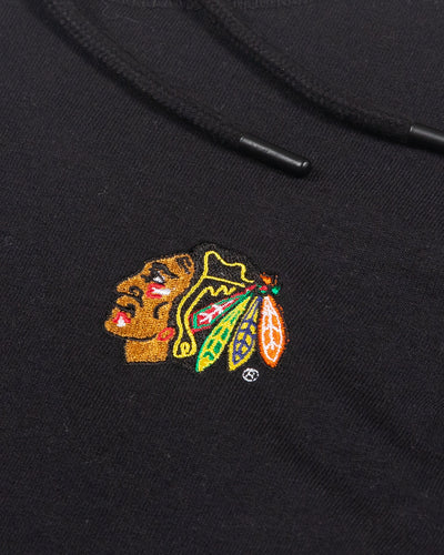 black and white striped Antigua zip up jacket with embroidered Chicago Blackhawks logo on left chest - detail lay flat
