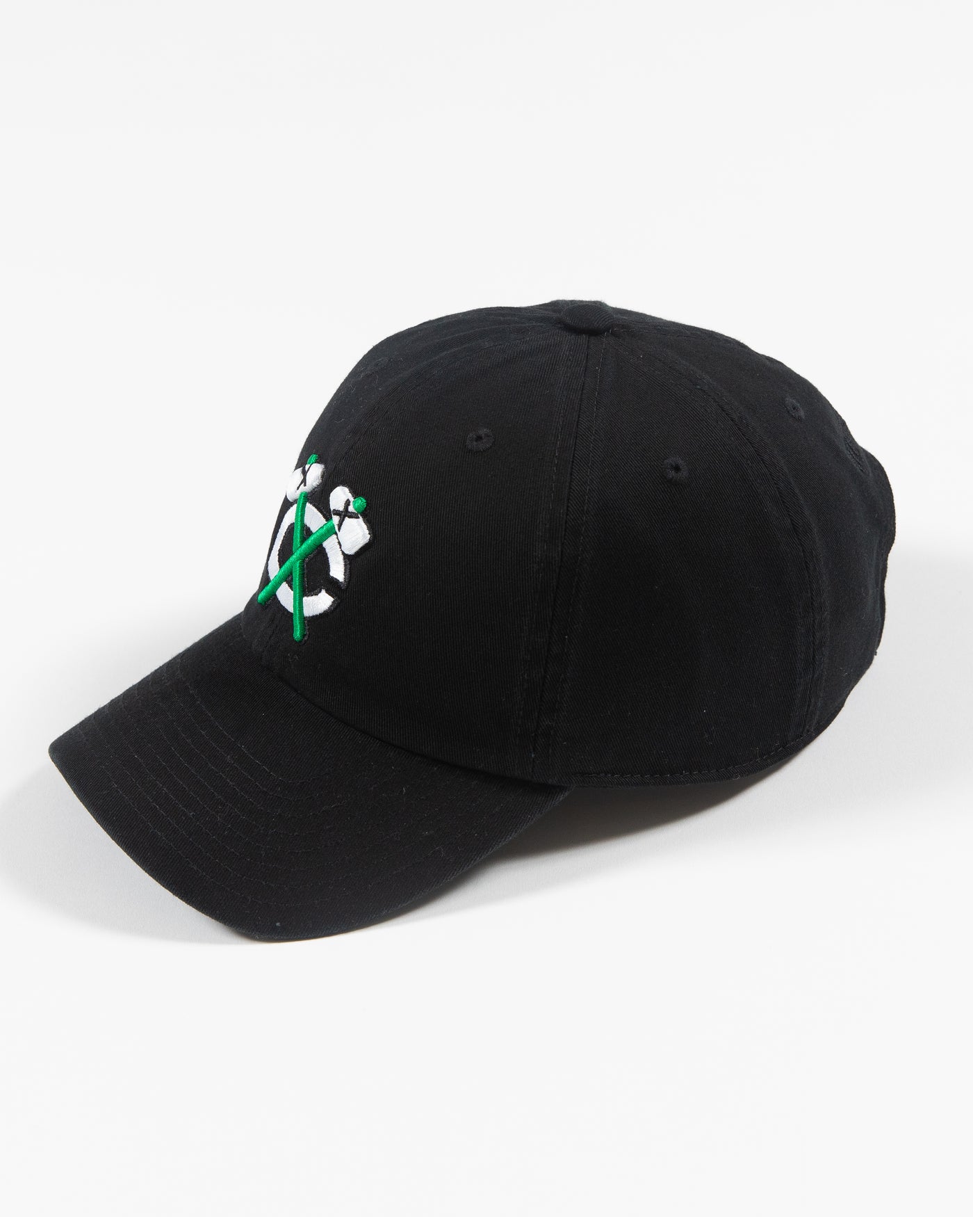 black adjustable cap with white and green Chicago Blackhawks secondary logo - left angle lay flat