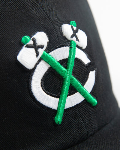 black adjustable cap with white and green Chicago Blackhawks secondary logo - detail lay flat