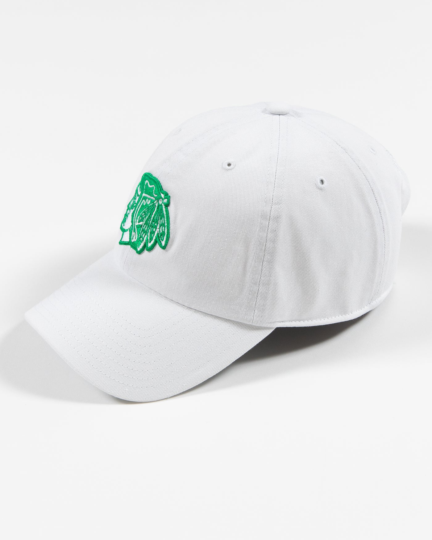 white adjustable cap with green Chicago Blackhawks primary logo - left angle lay flat