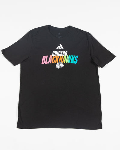 Black adidas short sleeve tee with Chicago Blackhawks wordmark graphic in Pride colorway and primary logo on center chest  - front lay flat