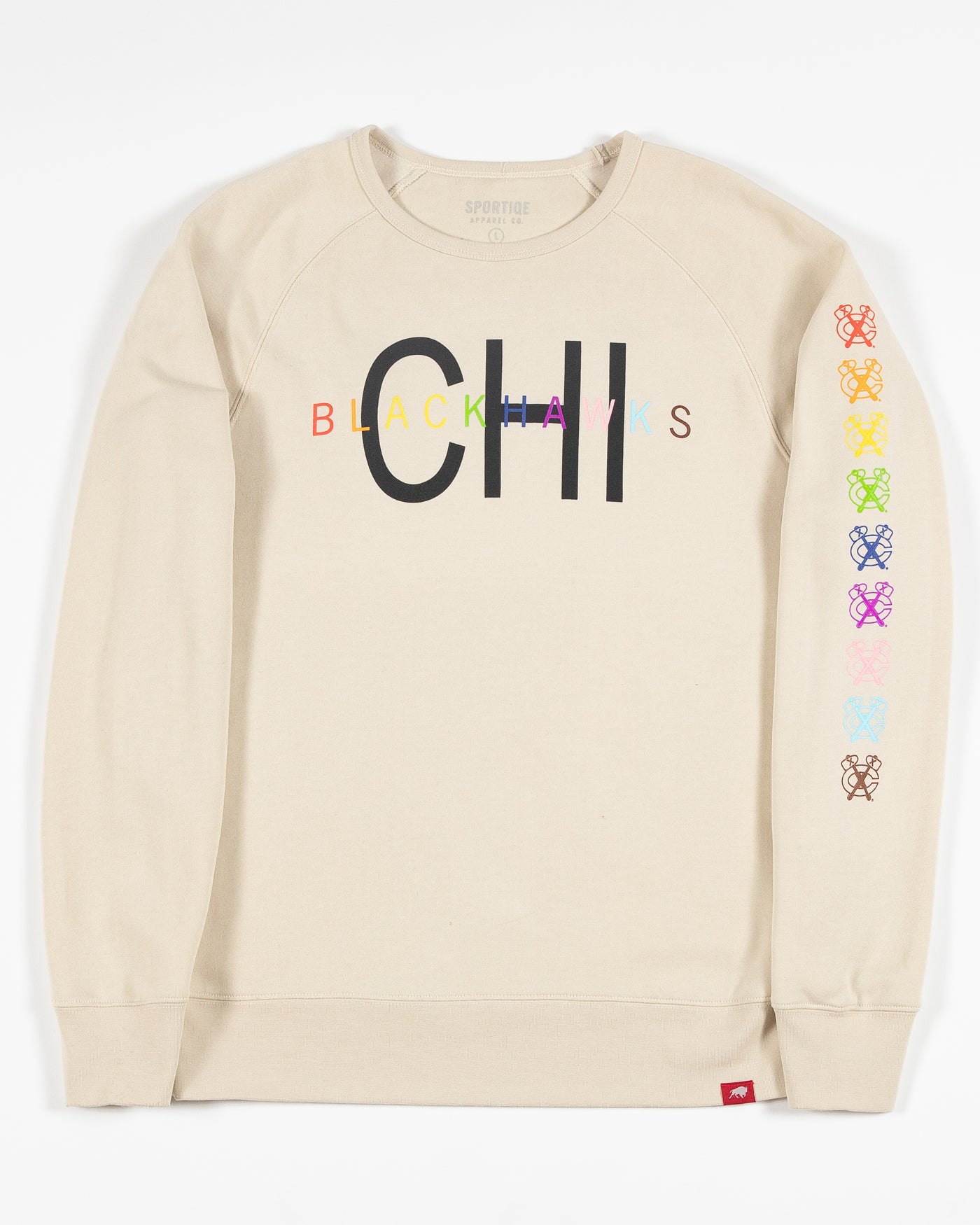 Off white colored crewneck with Chicago Blackhawks wordmark graphics in pride colorway along front chest and down left arm - front lay flat