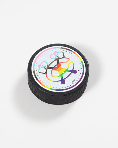 Puck with Chicago Blackhawks Secondary logo in Pride colorway - angled lay flat