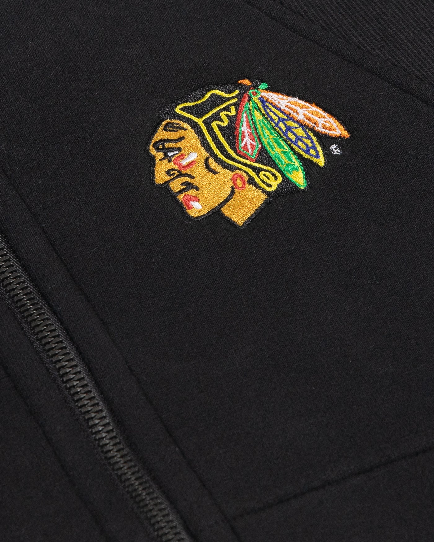 black oversized cropped lululemon hoodie with Chicago Blackhawks primary logo embroidered on left chest - detail lay flat