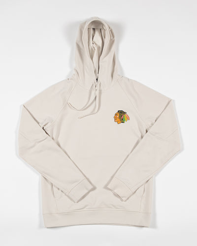 cream colored lululemon hoodie with Chicago Blackhawks full color log on left chest - front lay flat