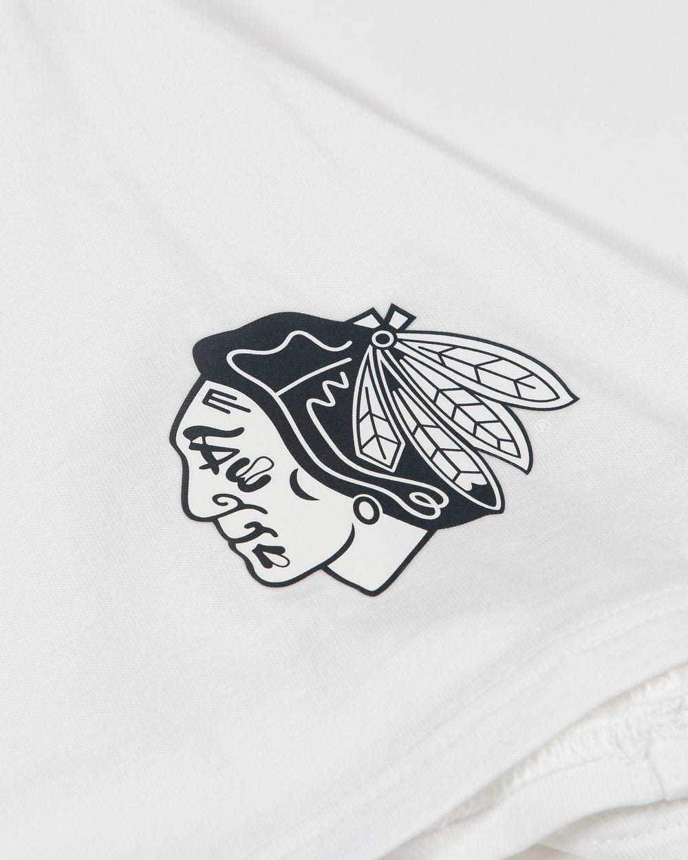 white lululemon tee with Chicago Blackhawks tonal primary logo on left shoulder - detail lay flat