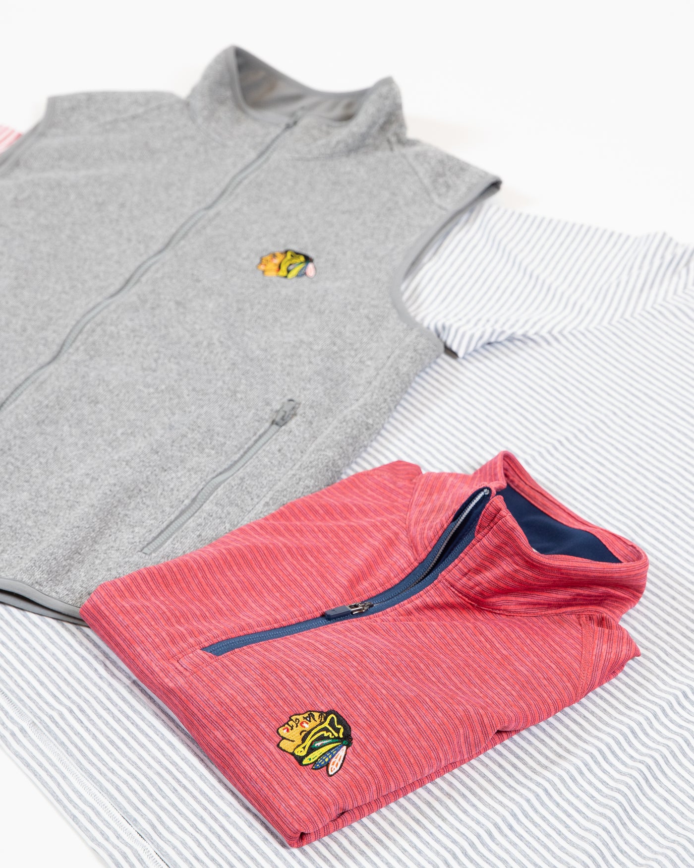 TravisMathew red 1/4 zip long sleeve with embroidered primary logo on left chest - collection flat lay