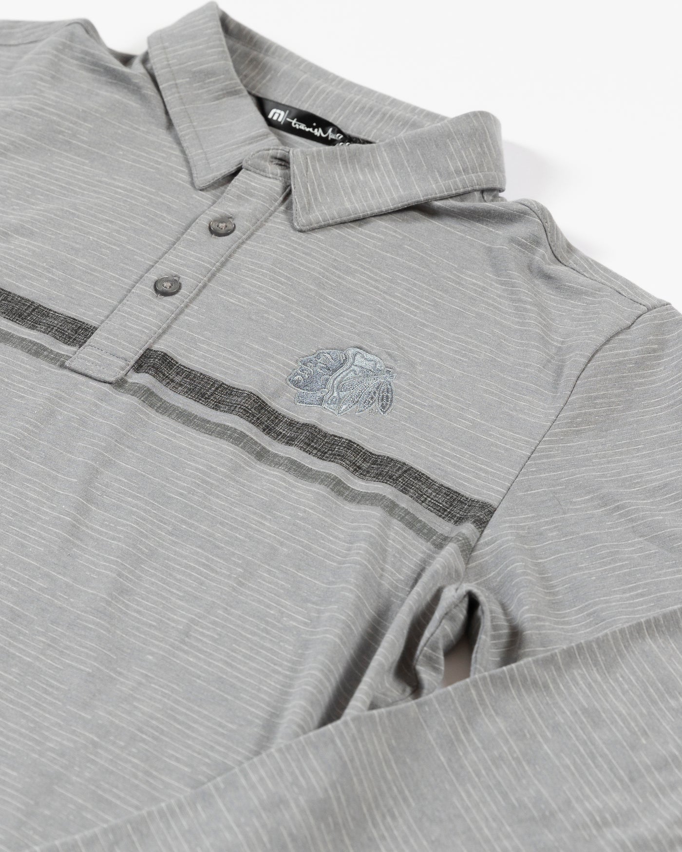 TravisMathew heather grey long sleeve polo with embroidered tonal primary logo on left chest - detail lay flat