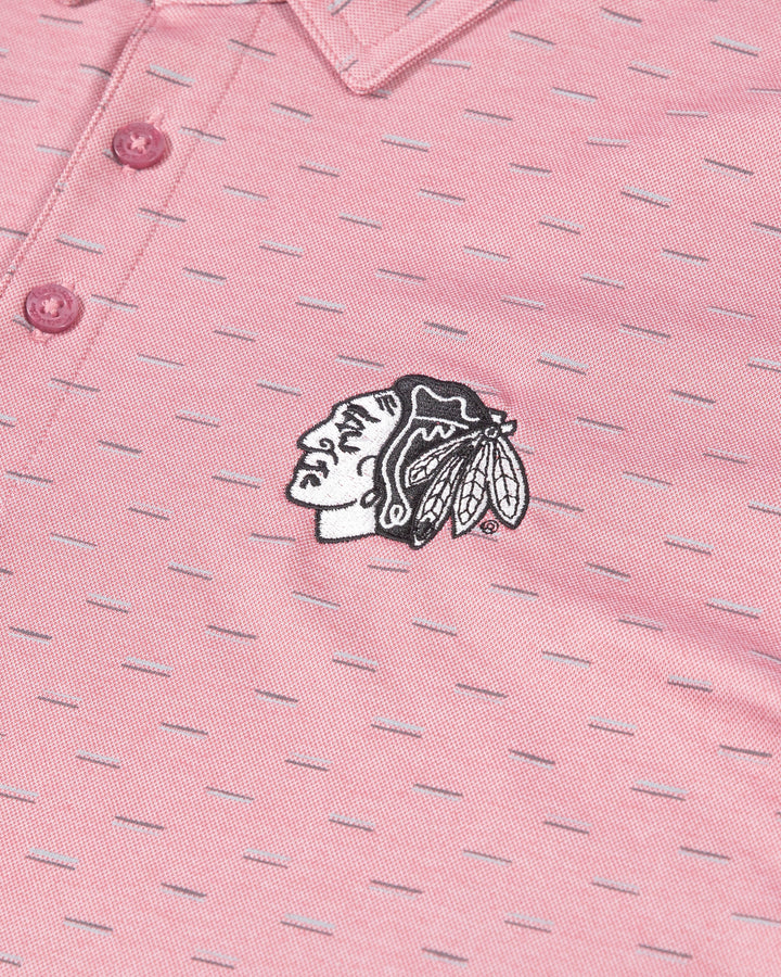 red geo print TravisMathew polo with embroidered tonal Chicago Blackhawks primary logo on left chest - detail lay flat