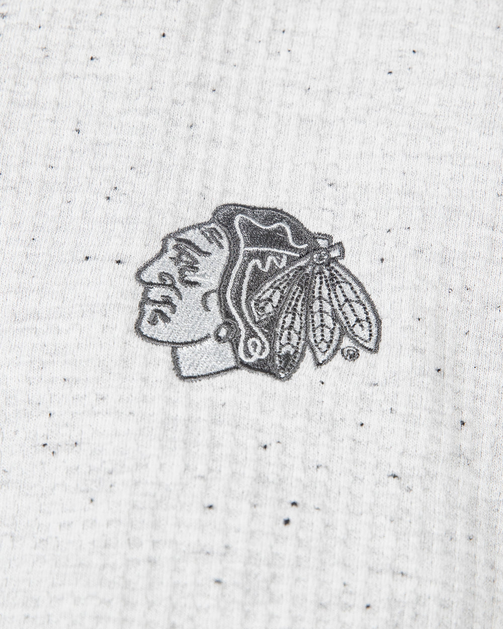 light grey TravisMathew waffle knit hoodie with tonal Chicago Blackhawks primary logo embroidered on left shoulder - detail lay flat