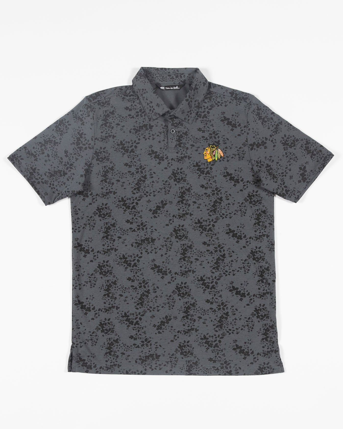 black floral print TravisMathew polo with embroidered Chicago Blackhawks primary logo embroidered on left chest - front lay flat