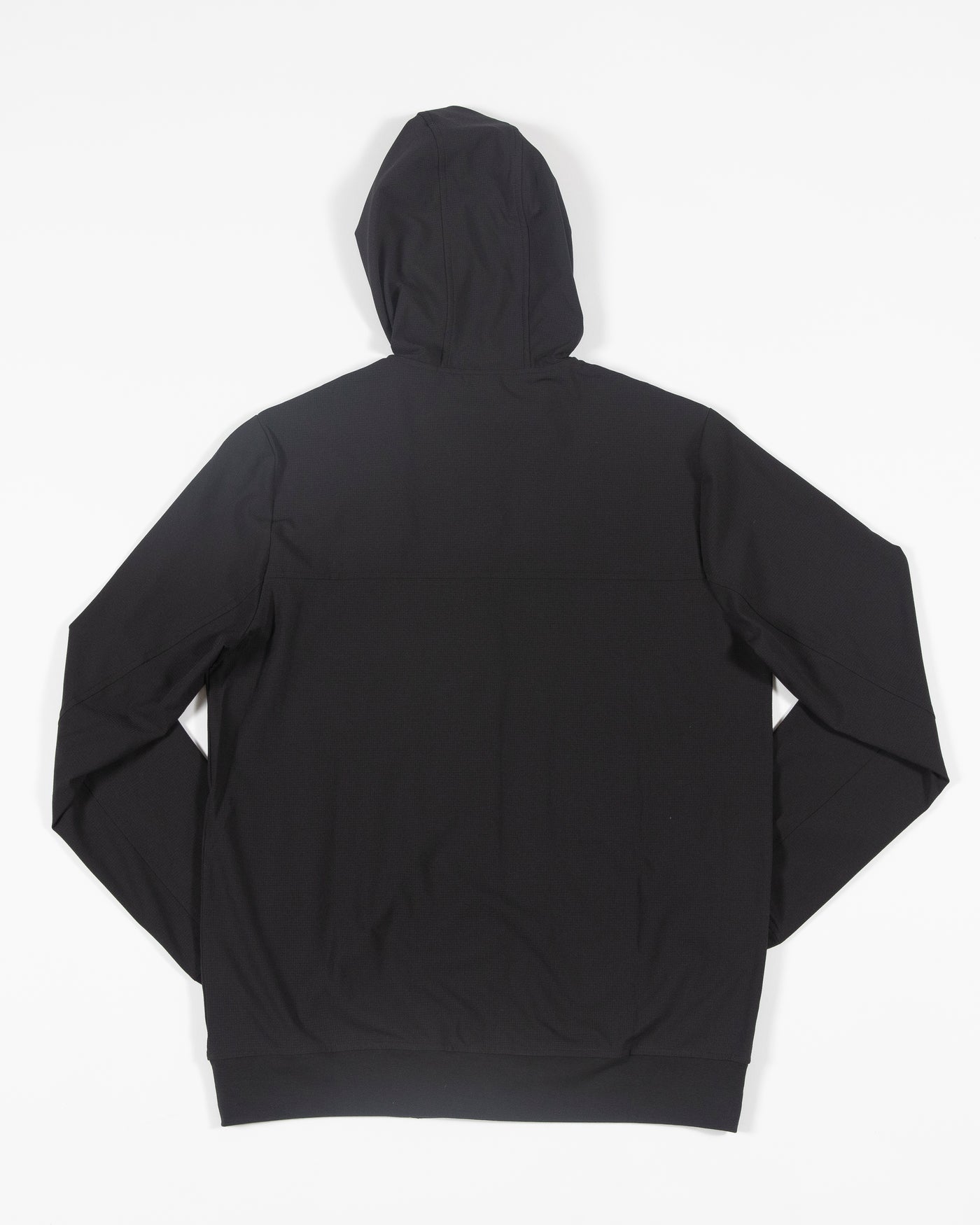 black TravisMathew zip up hoodie with embroidered Chicago Blackhawks primary logo on left shoulder - back lay flat