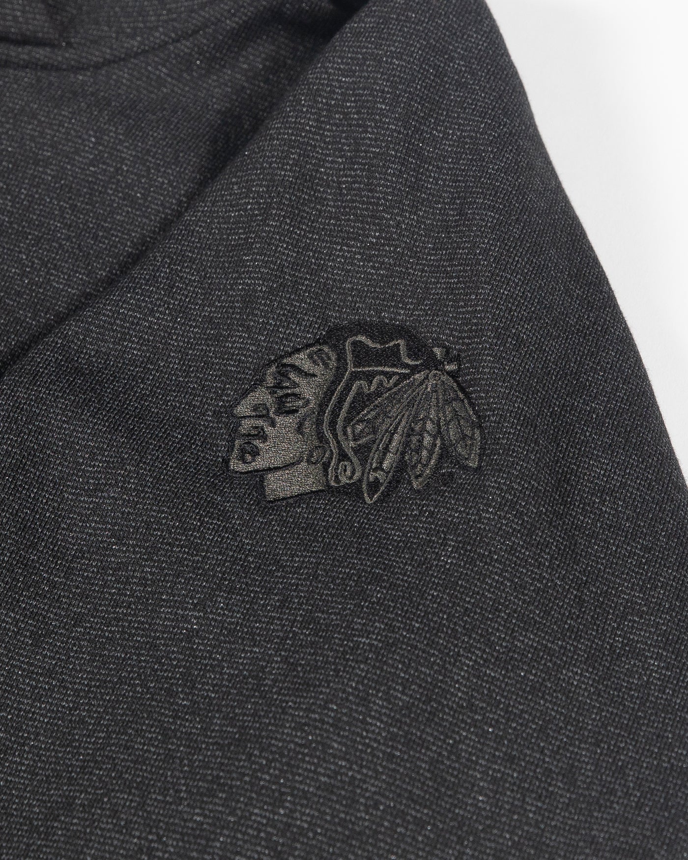 black cropped lululemon hoodie with tonal Chicago Blackhawks primary logo embroidered on left shoulder - detail lay flat