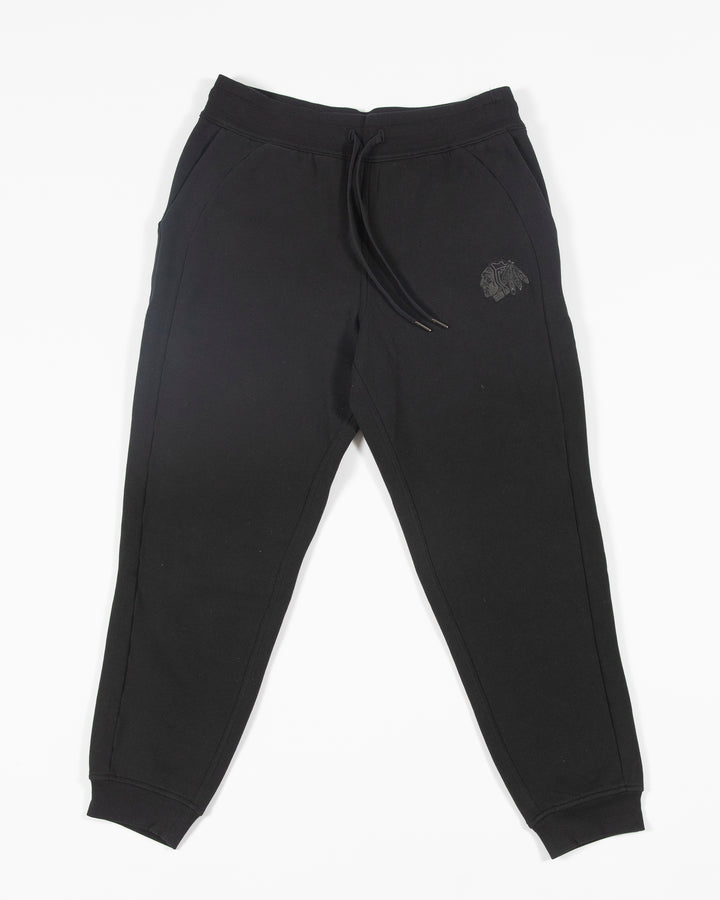 black lululemon joggers with tonal Chicago Blackhawks primary logo embroidered on left leg - front lay flat